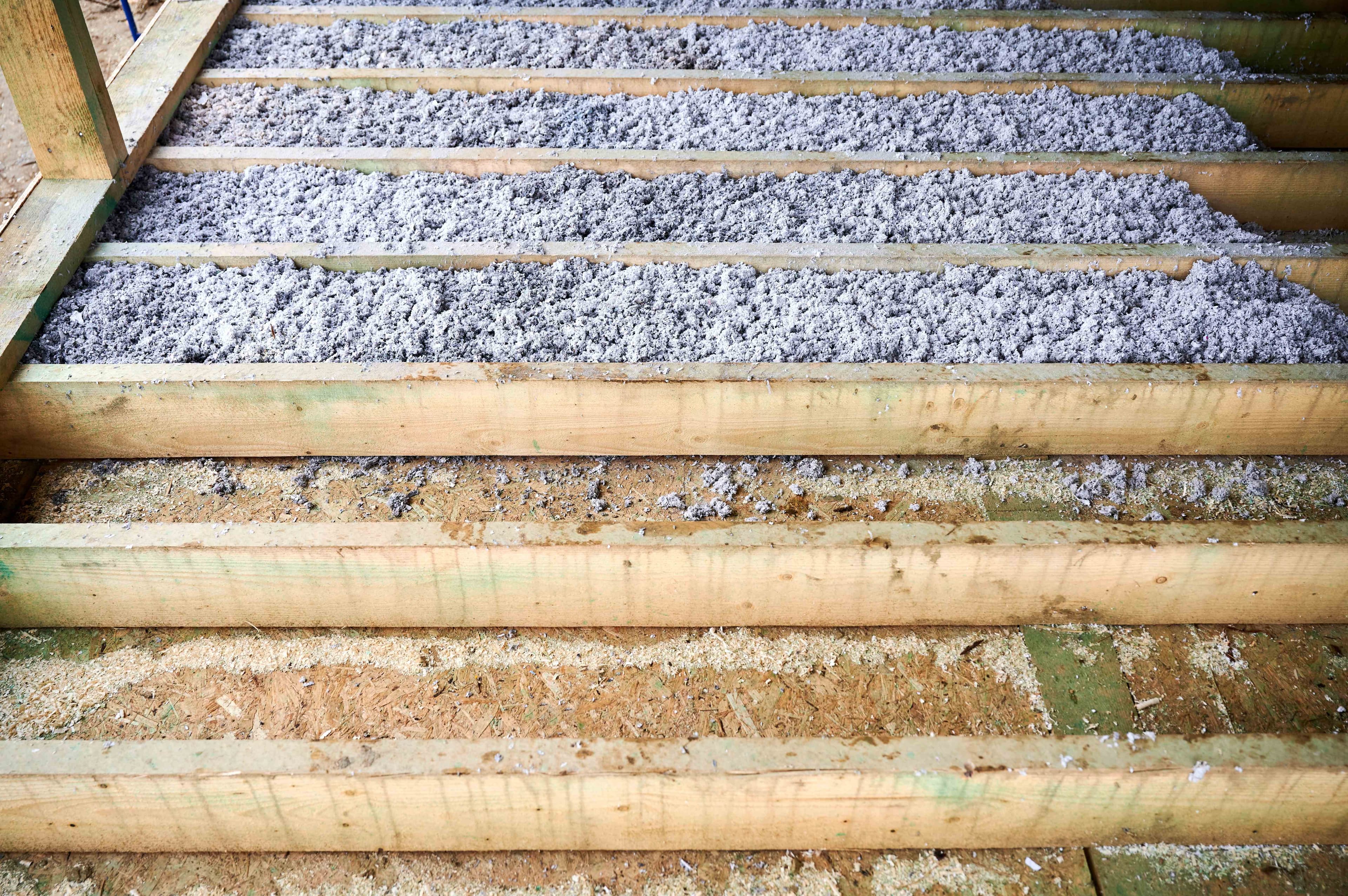 Blown-in loose-fill insulation covering an attic floor between joists