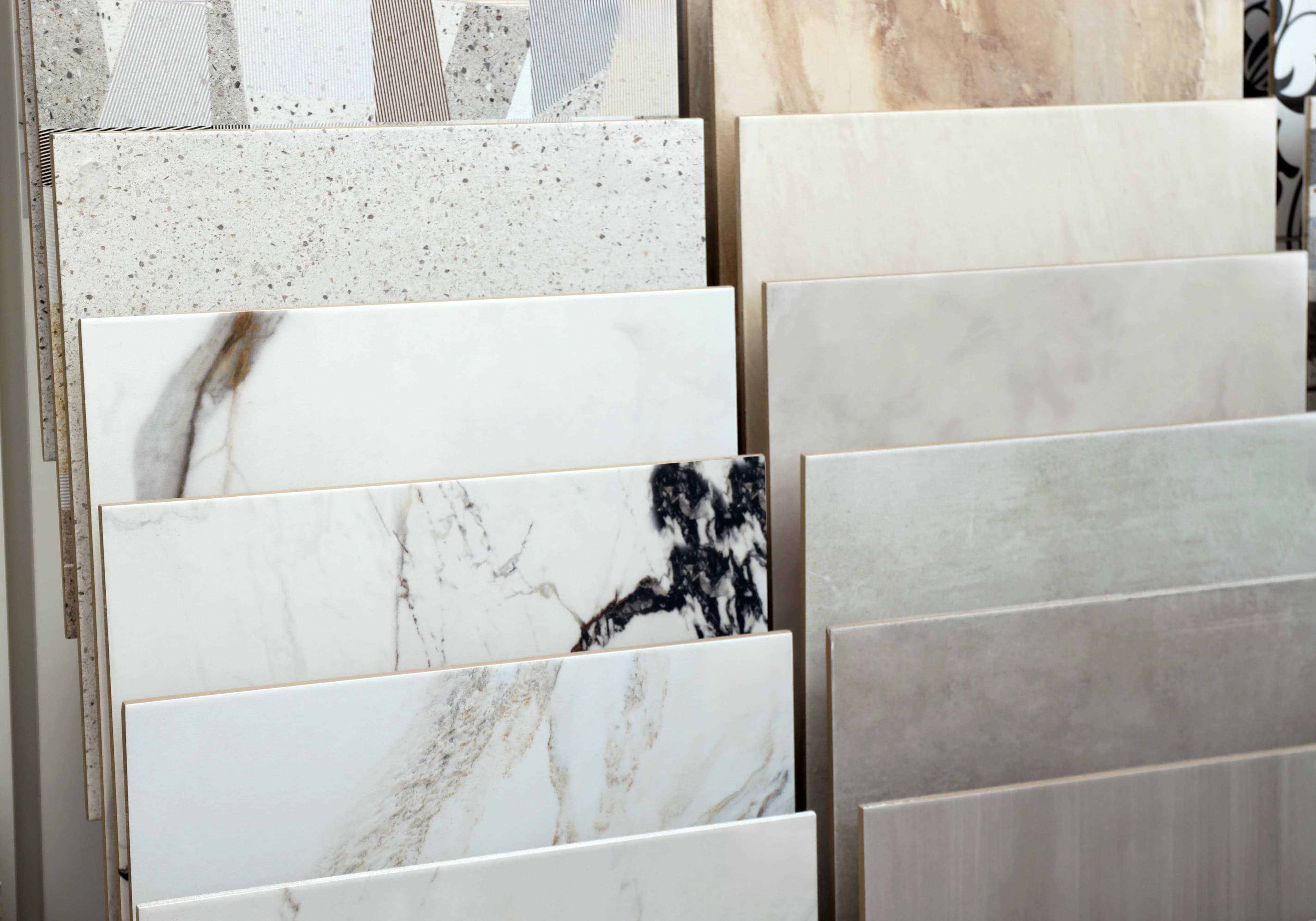A display of stone-look and marble-pattern tile samples used to select matching bathroom finishes.