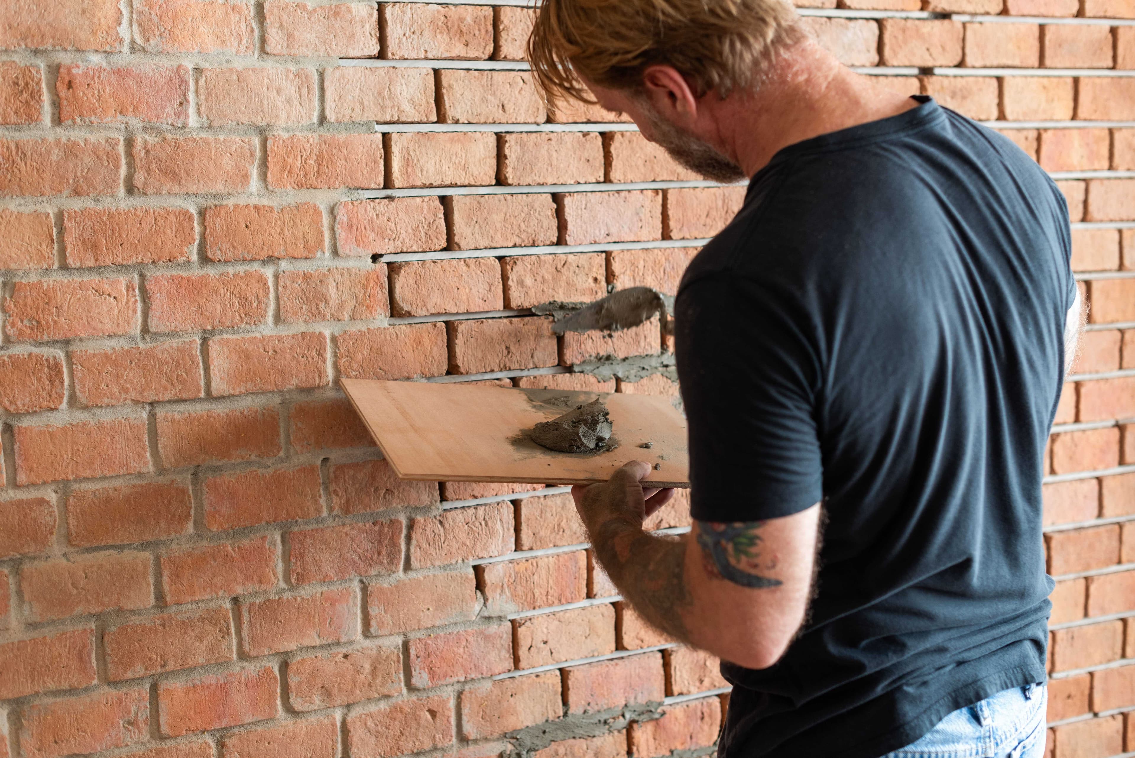 Repointing mortar joints on a brick wall