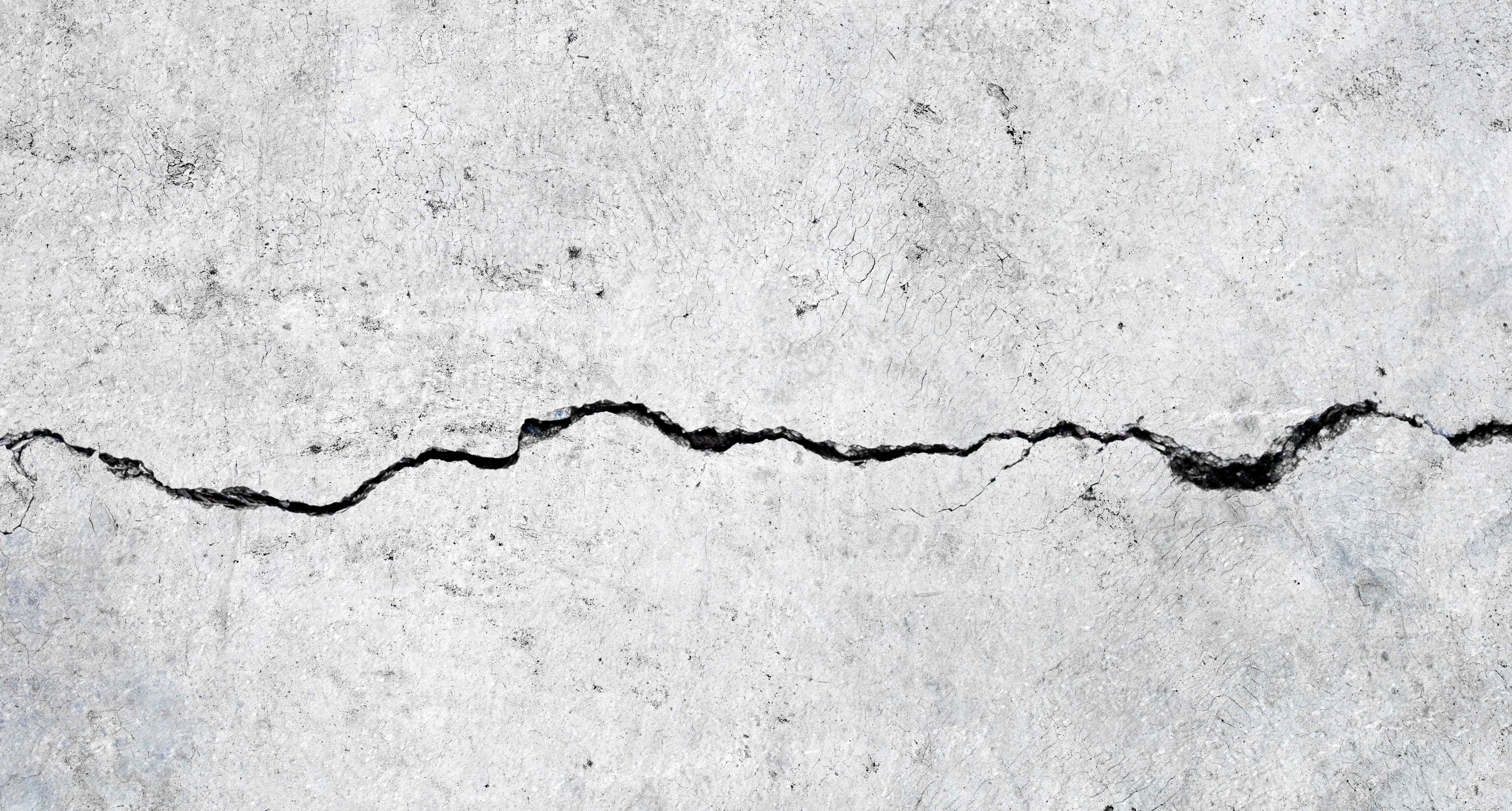 Close-up of a cracked and deteriorated concrete surface