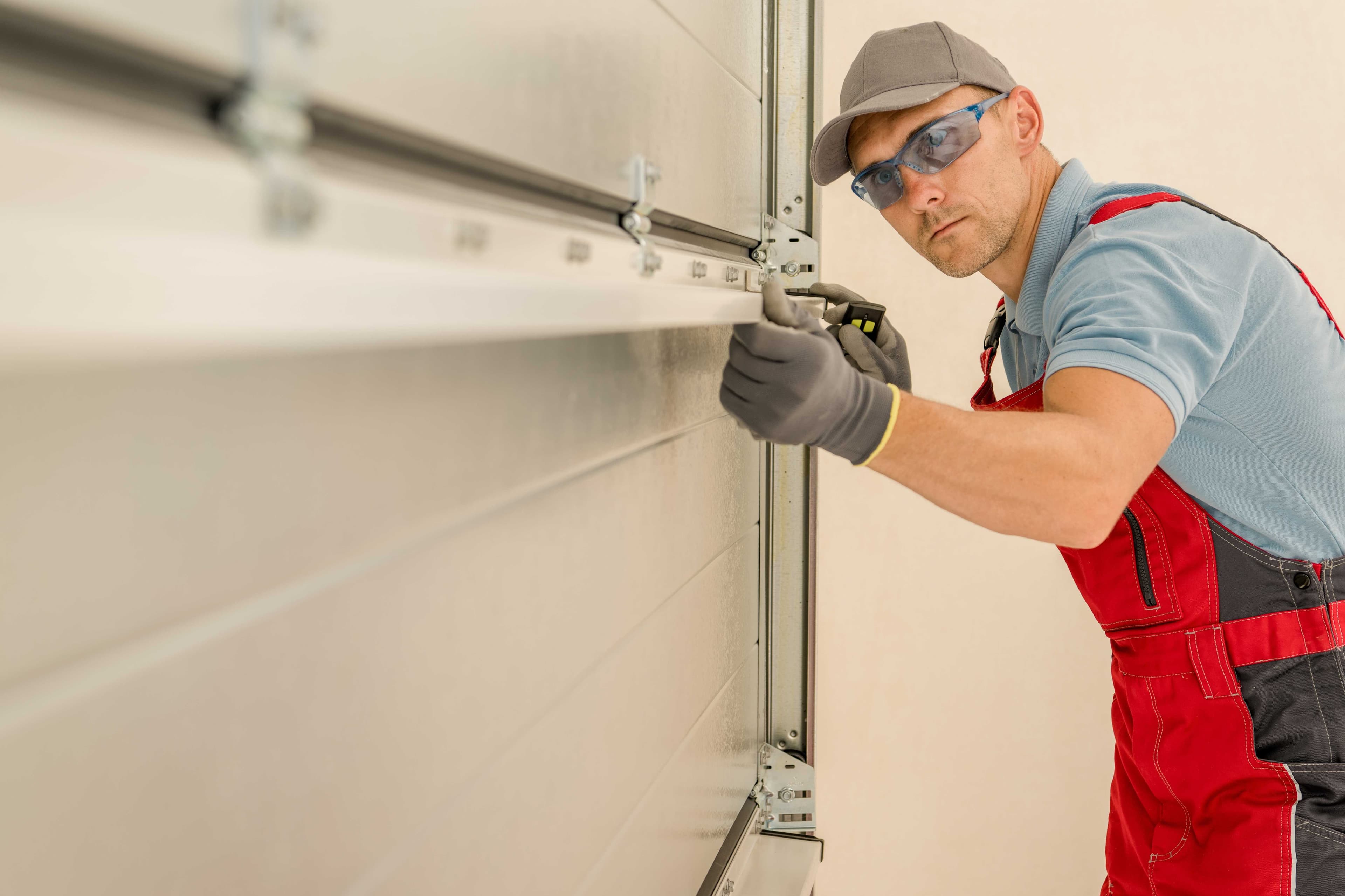 Technician adjusting a garage door track bracket