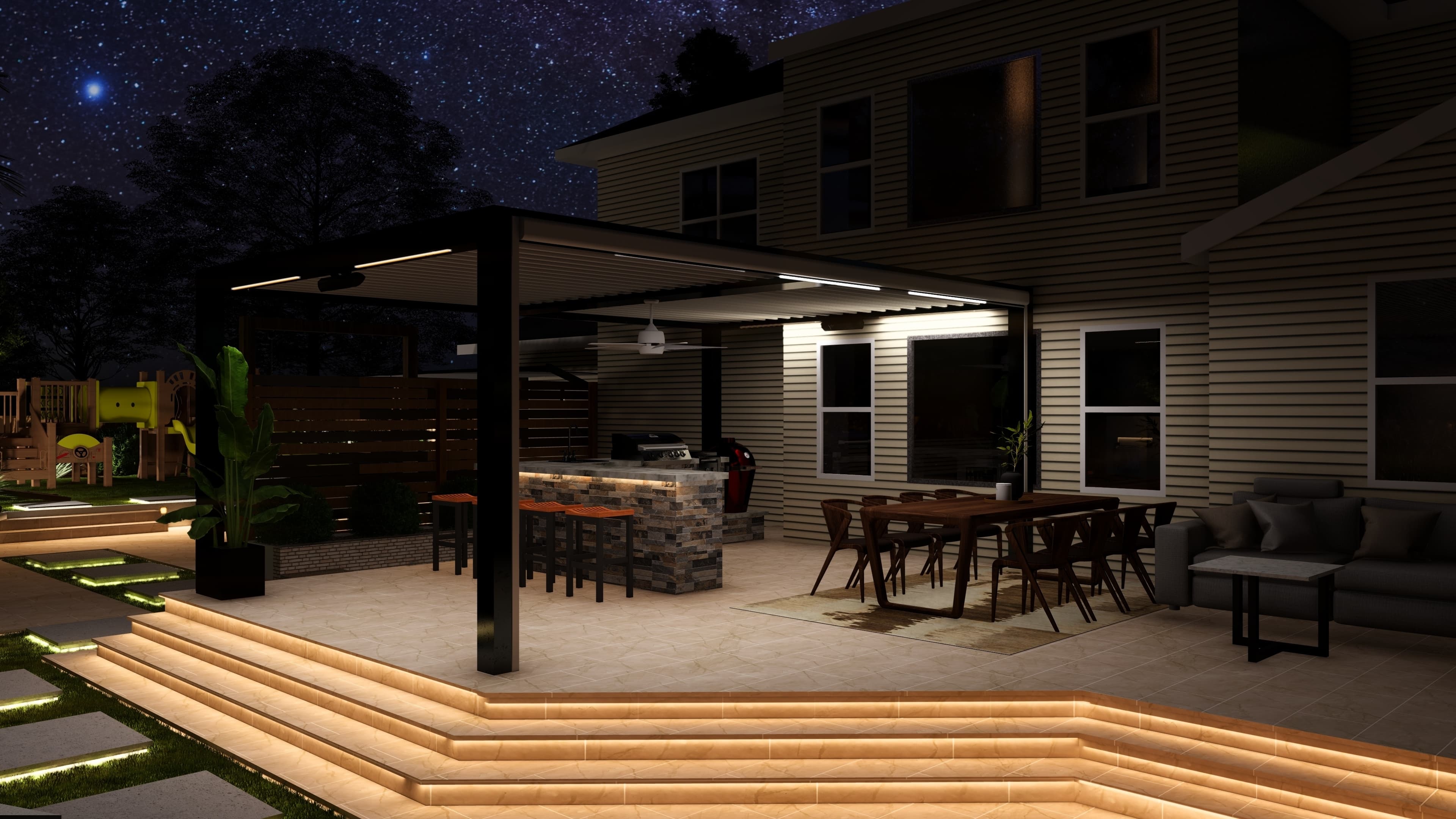 A black louvered pergola lit at night over a patio with an outdoor kitchen, dining table, and illuminated steps.