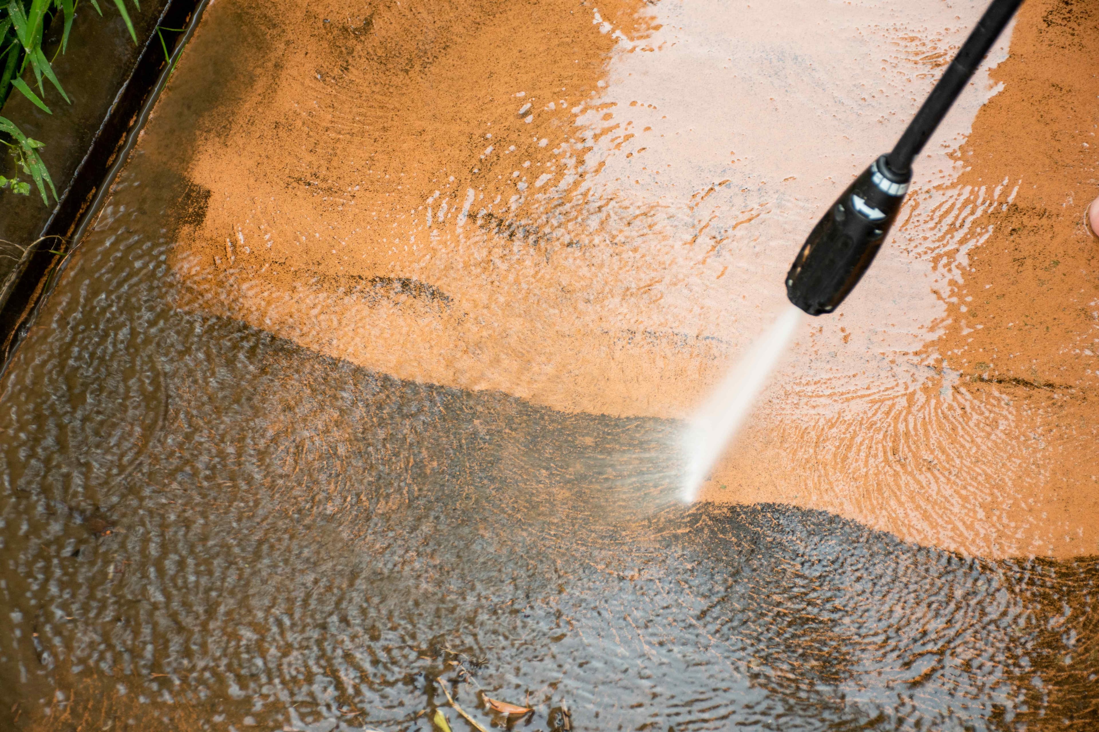 Pressure washer cleaning a concrete surface