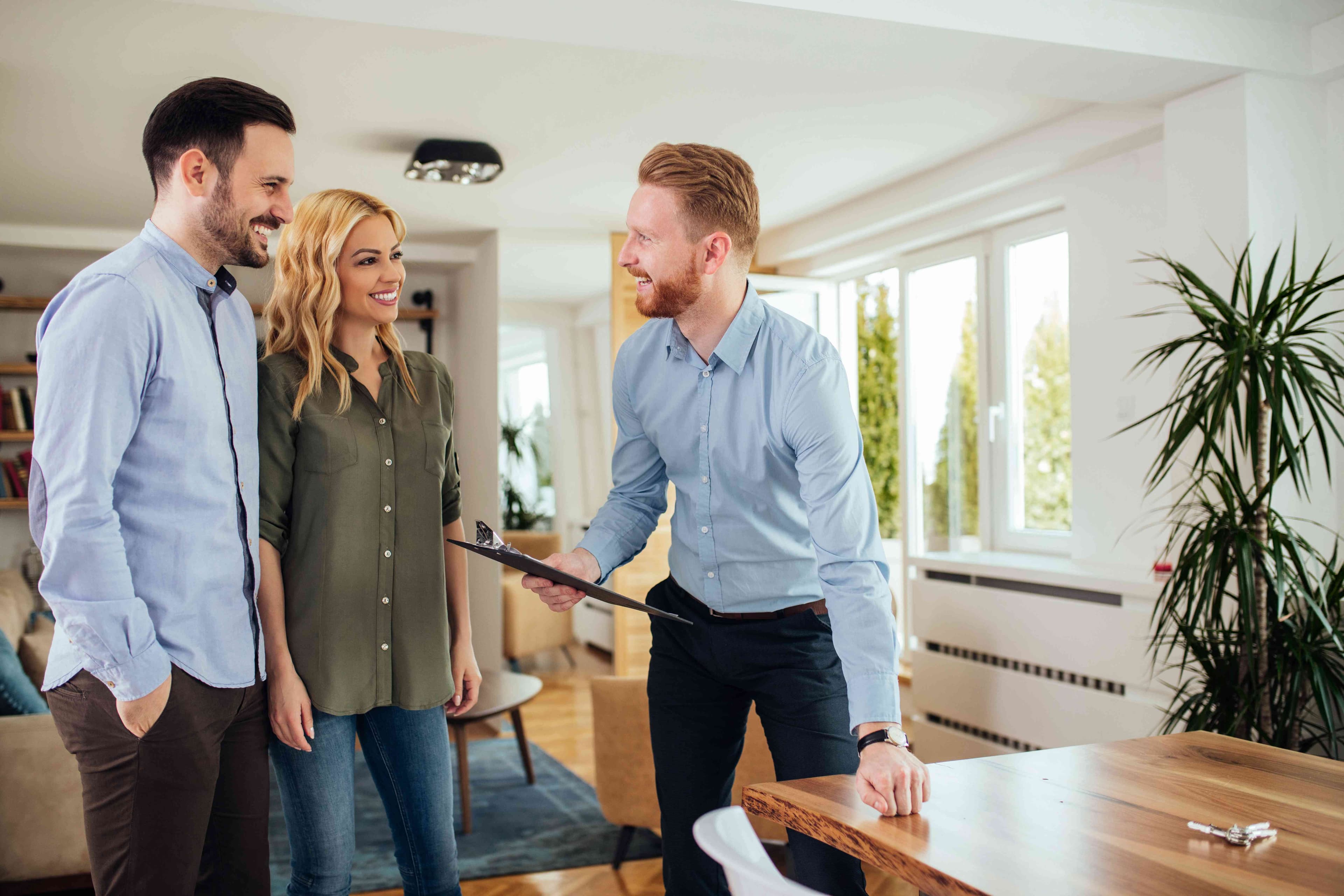 Professional discussing rental property repairs with a couple in their home