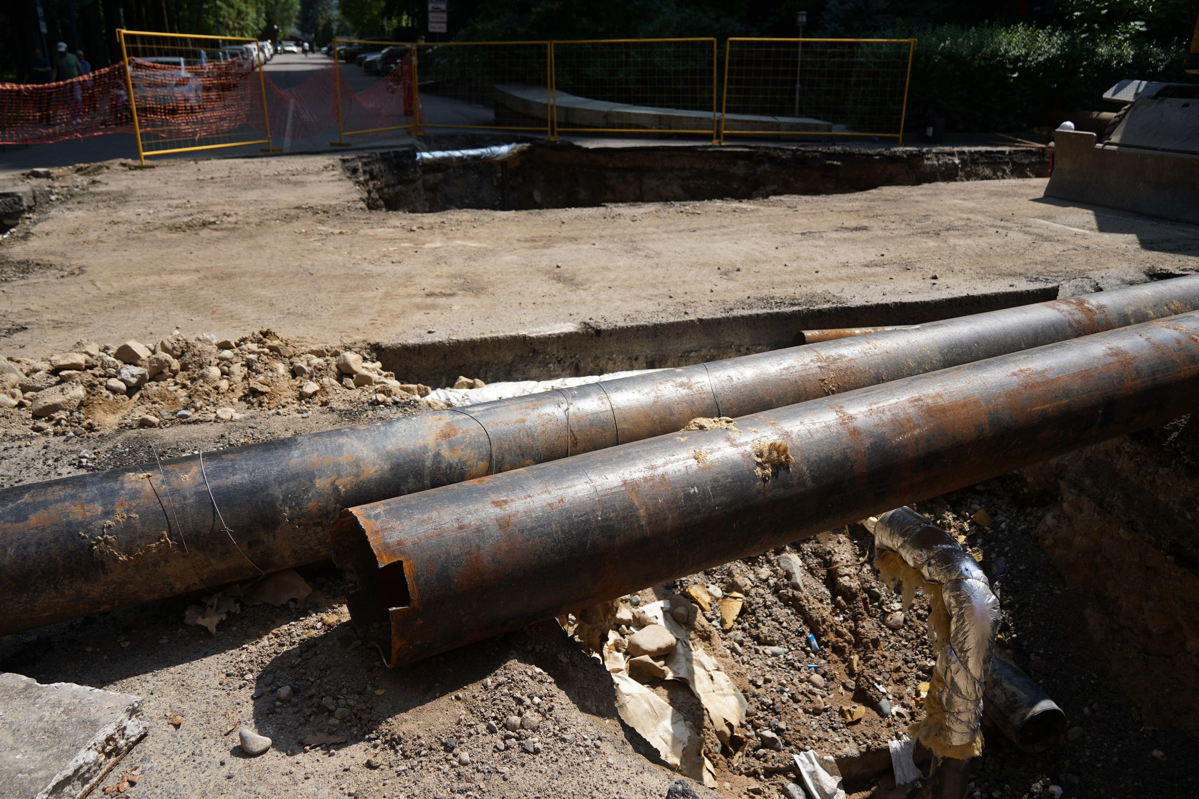Excavated utility pipes exposed during underground home infrastructure repair